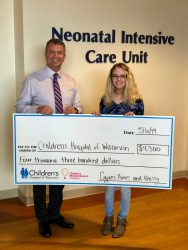 Cypress Homes President, Mike Blank, with his daughter Lucy presenting check.