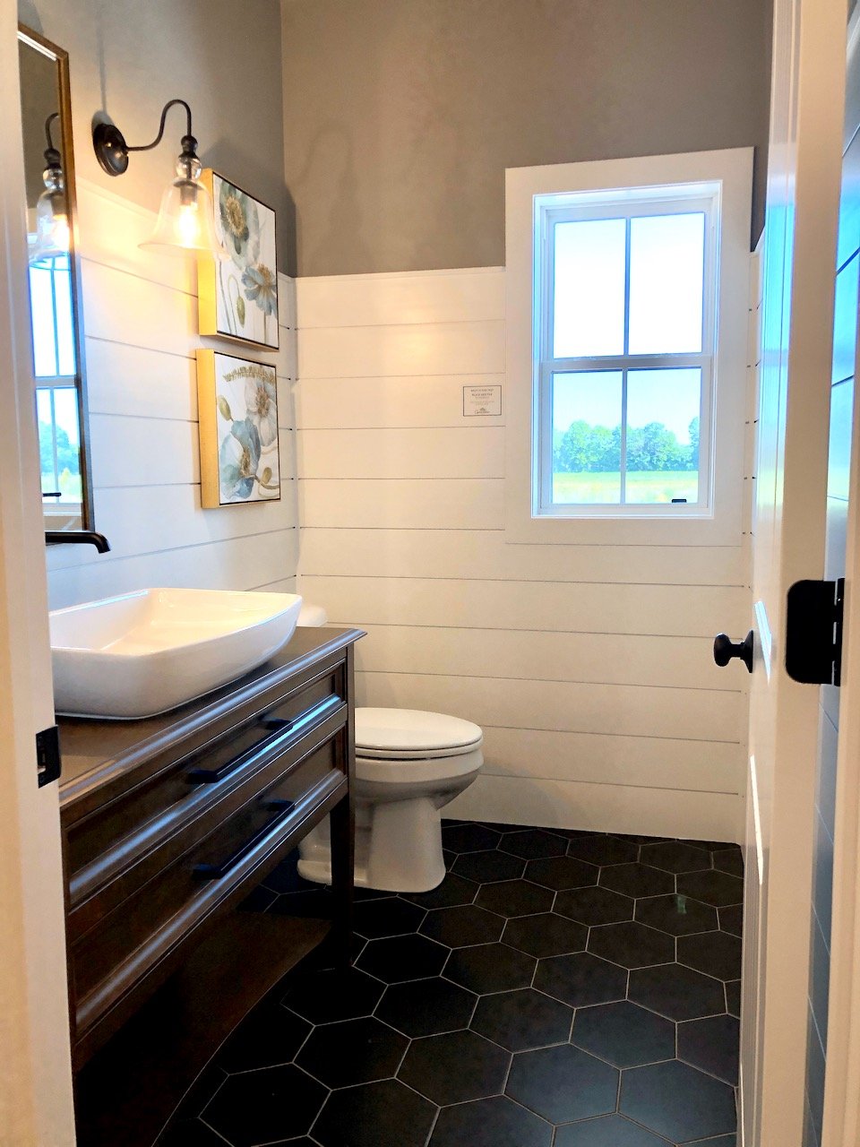 Modern powder room with white ship lap and vessel sink